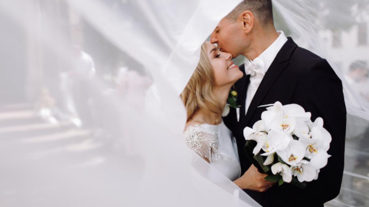 groom_black_tuxedo_hugs_tender_stunning_bride_while_they_stand_8353_8050_71892100