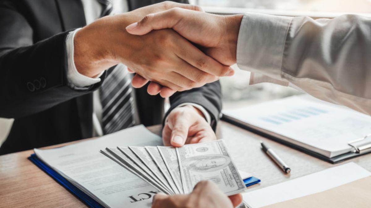 businessman_shaking_hands_giving_dollar_bills_business_manager_45041_162_88522700