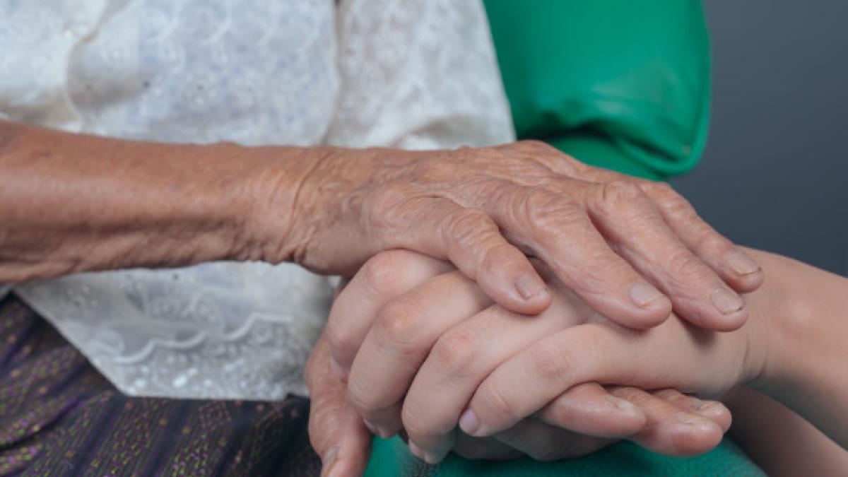 young_woman_holding_elderly_woman_s_hand_1150_12495_57760500