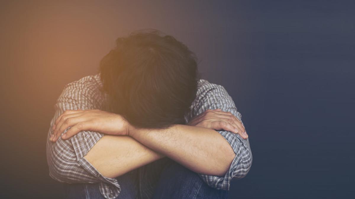 sad_man_holding_head_with_hand_1150_6346_83306800