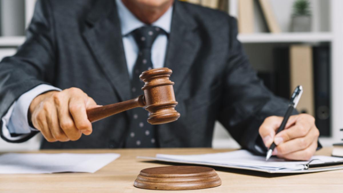 male_lawyer_writing_document_courtroom_giving_verdict_by_hitting_mallet_gavel_23_2147898261_13659700