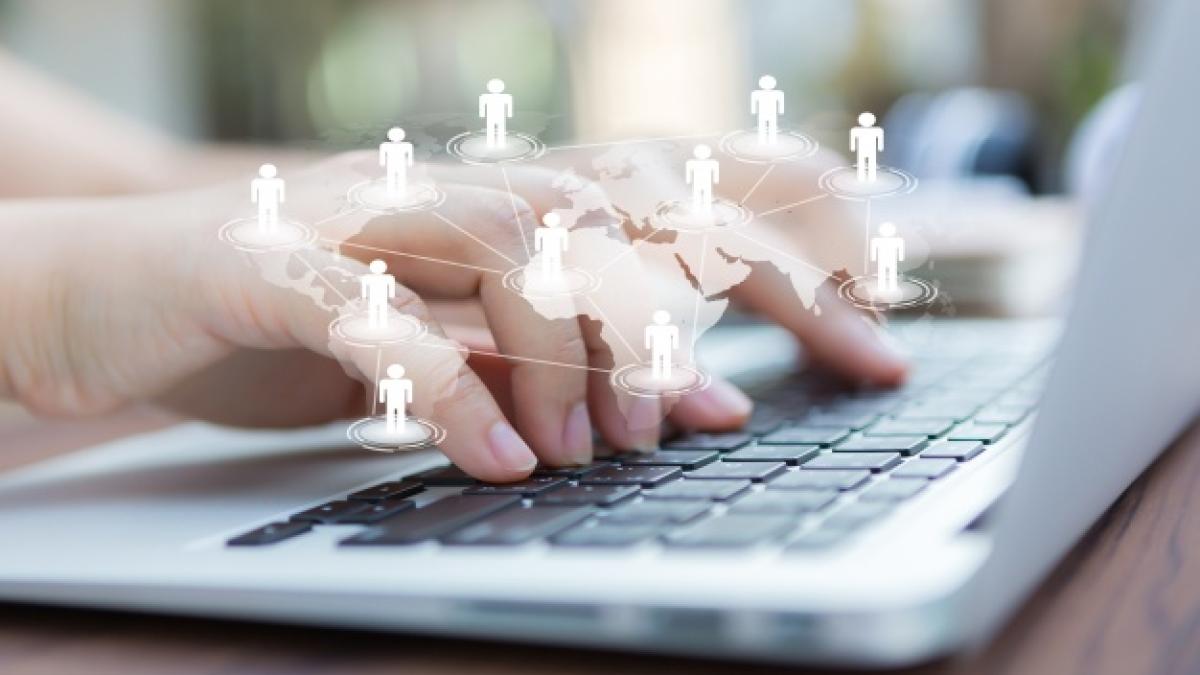 hands_with_laptop_virtual_world_map_1232_876_95979600