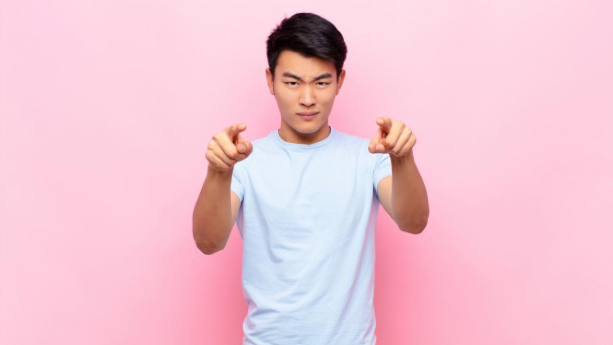 young_chinese_man_pointing_forward_1194_53478_65287600