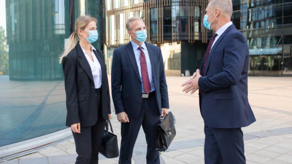 three_content_business_partners_masks_discussing_deal_outside_confident_successful_managers_standing_street_working_during_coronavirus_pandemic_negotiation_partnership_concept_74855_7846_08302600