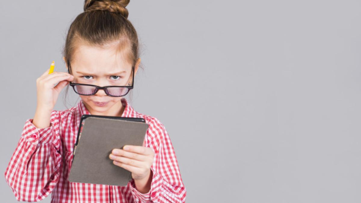 confused_little_girl_glasses_using_tablet_23_2148085249_66850900