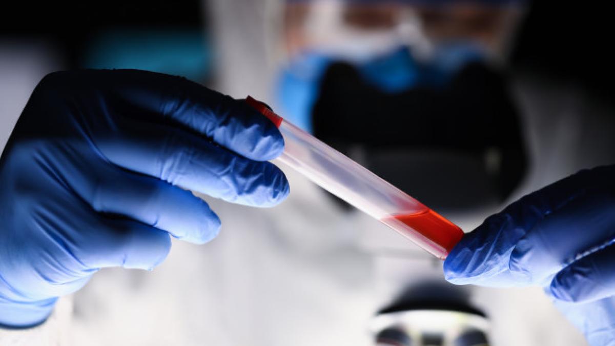 male_chemist_examining_blood_sample_dark_laboratory_151013_5351_13460800