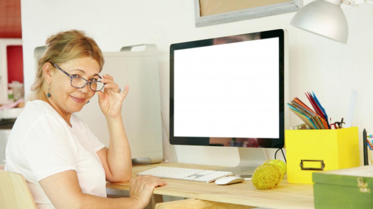 beautiful_mature_blonde_female_pensioner_spectacles_sitting_front_computer_273609_1168_69858300