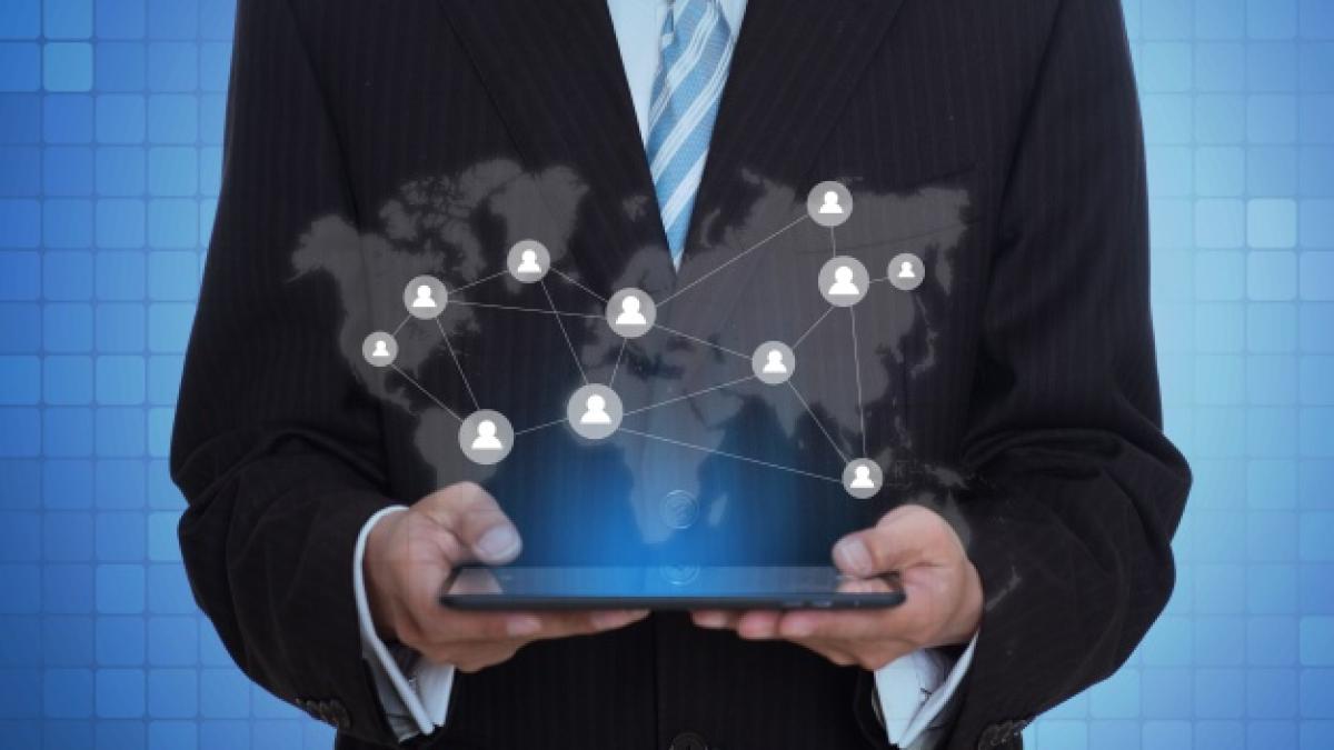 businessman_holding_tablet_with_virtual_application_1112_775_26311200