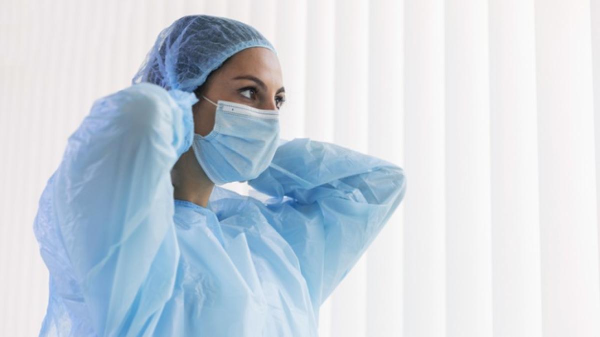 side_view_woman_putting_protective_mask_23_2148722359_77374500