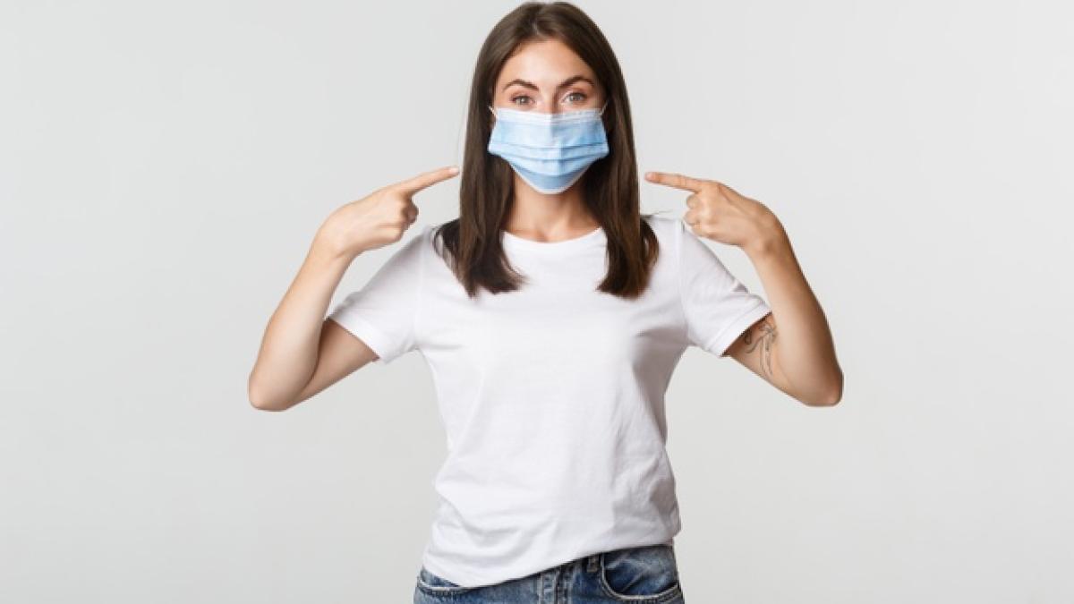 covid_19_health_social_distancing_concept_attractive_brunette_girl_medical_mask_pointing_finger_face_white_1258_19147_91137700