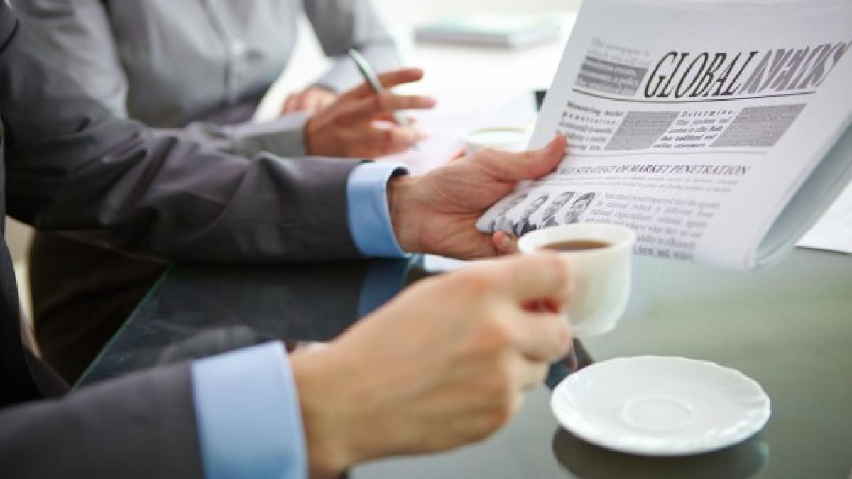 close_up_executive_with_coffee_newspaper_1098_2762_61869200