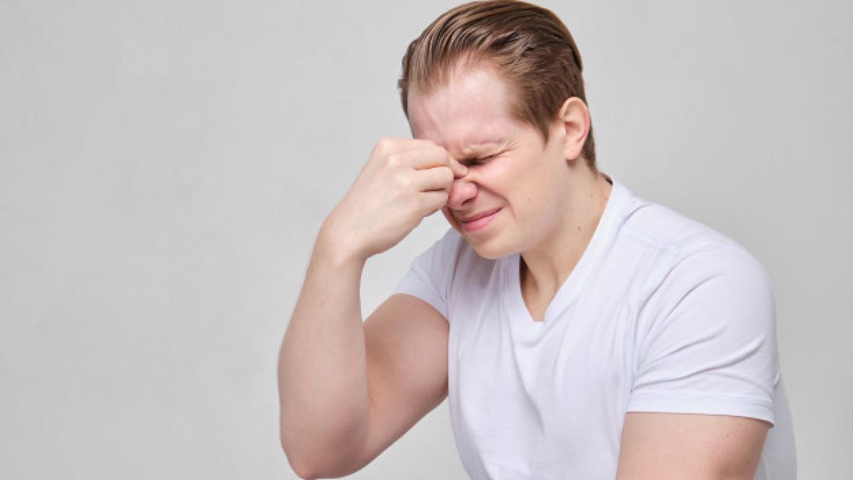 man_massages_bridge_his_nose_from_aching_pain_102583_1896_30116500