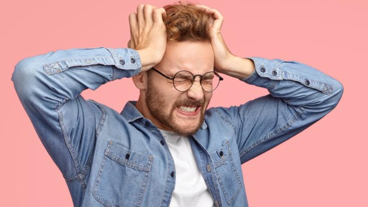 young_unshaven_stressful_man_suffers_from_headache_keeps_hands_temples_clenches_teeth_has_terrible_pain_closes_eyes_273609_18540_43928000