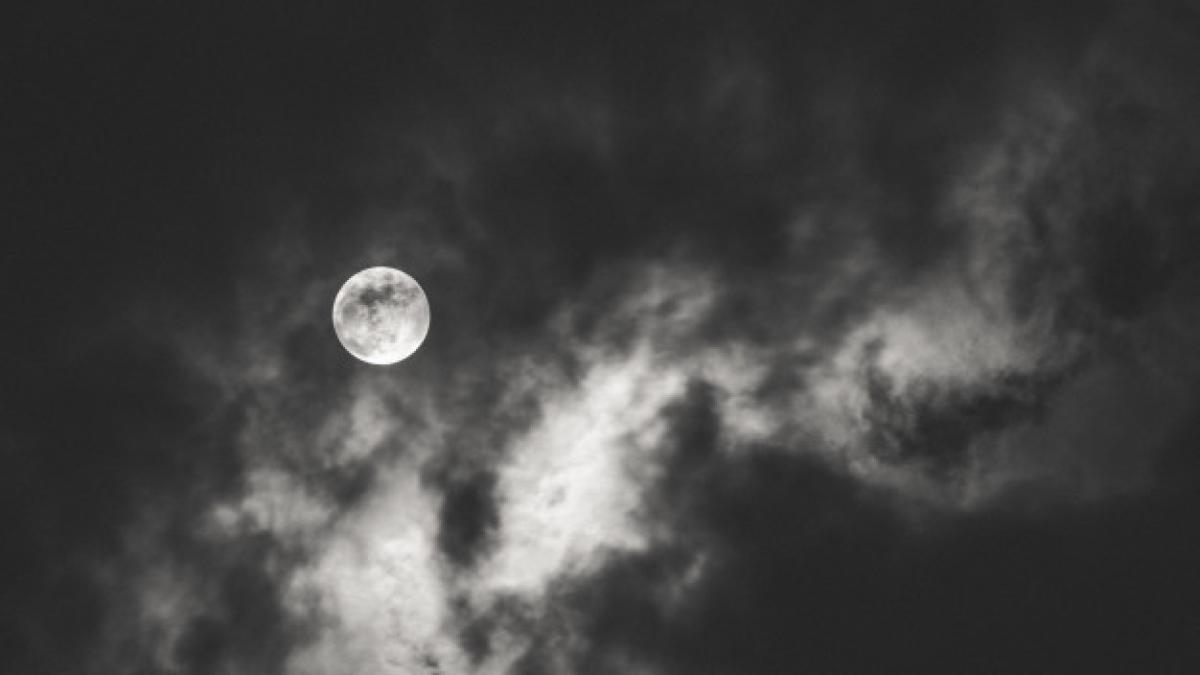 dark-shot-full-moon-spreading-light-clouds-during-nighttime_181624-4338_36714000