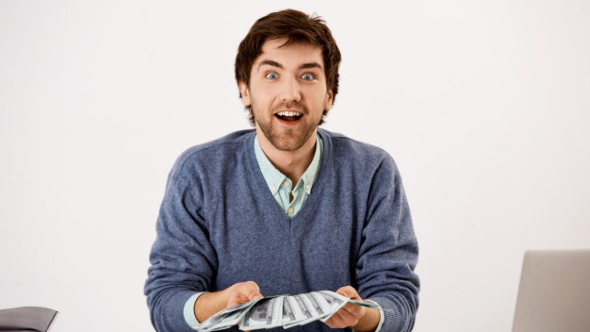 surprised-excited-man-express-overjoy-as-counting-money-received-lots-cash-holding-dollars-staring-happy_176420-15889_49063100