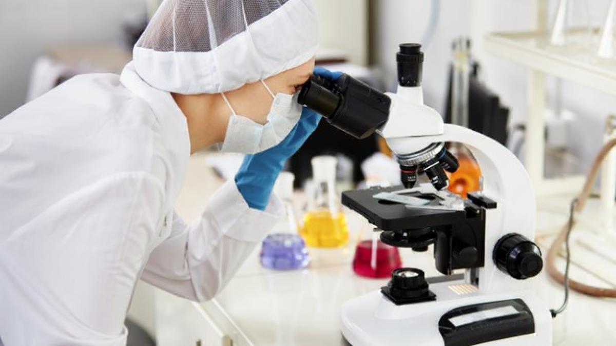 young-woman-medical-researcher-looking-through-microscop-slide-life-science_273609-13614_18943200