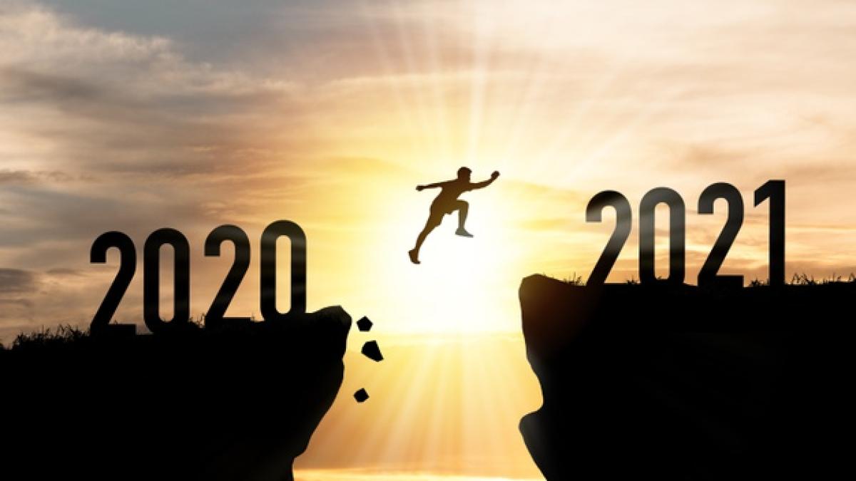 welcome-merry-christmas-happy-new-year-2021-silhouette-man-jumping-from-2020-cliff-2021-cliff-with-cloud-sky-sunlight_50039-1843_43966100