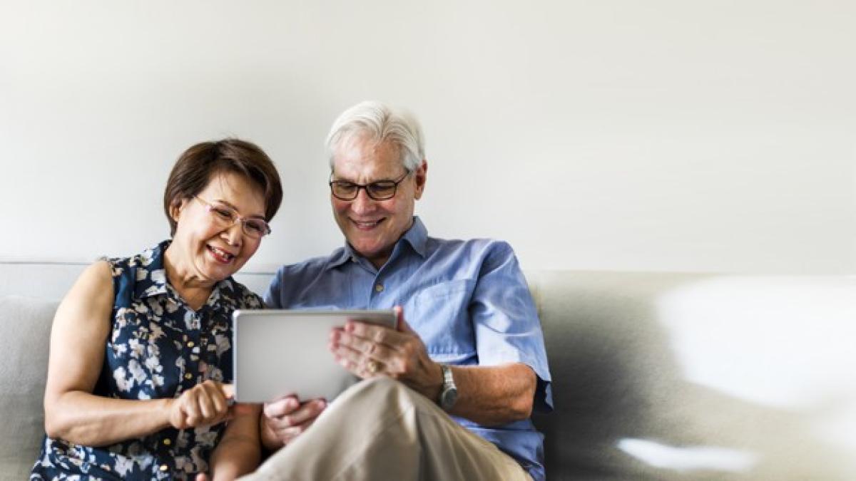 senior-couple-using-digital-device-living-room_53876-94579_97635100