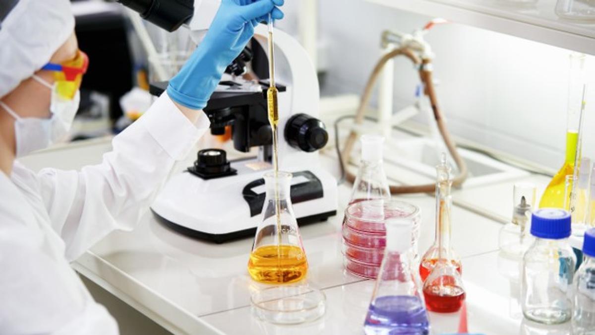 young-female-scientist-mixing-reagents-from-glass-flasks-making-test-research-clinical-laboratory_273609-13626_22764300