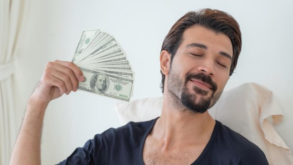 business-man-holding-money-us-dollar-bills-home-office_1150-35113_92325300