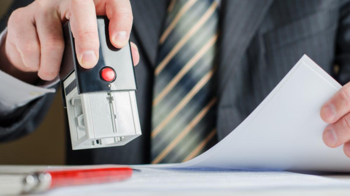 lawyer-notary-puts-seal-document-stamp-man-s-hand_76255-440_26594700