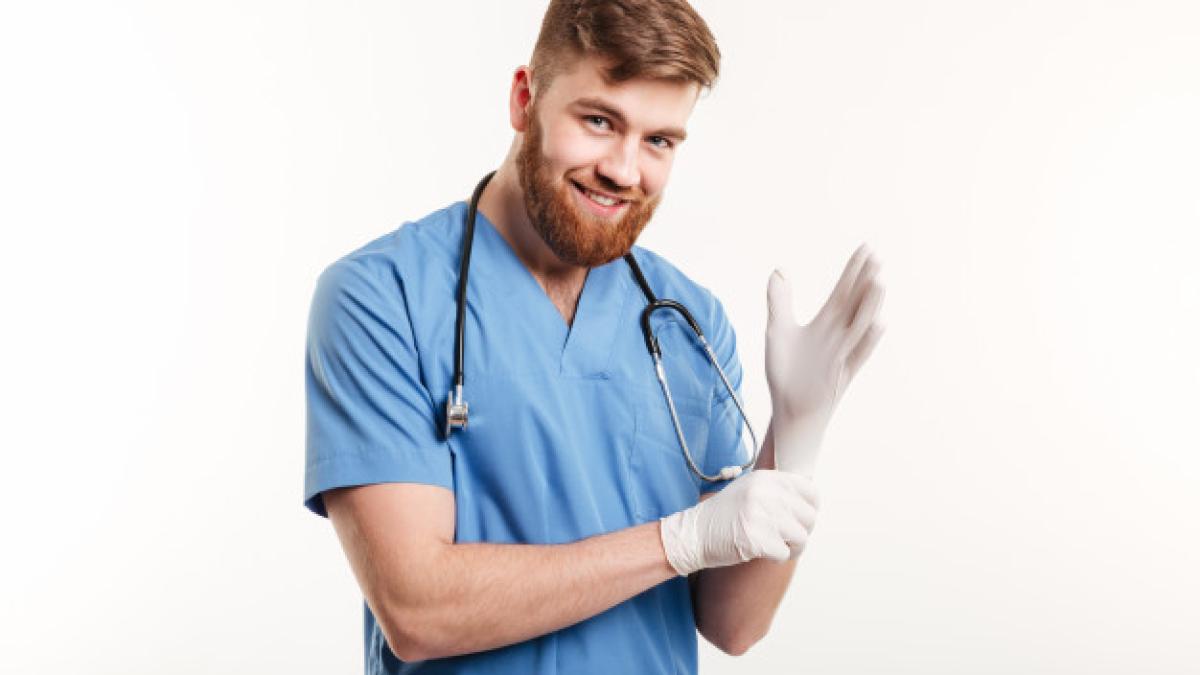 portrait-smiling-friendly-doctor-putting-sterile-gloves_171337-15771_76435200