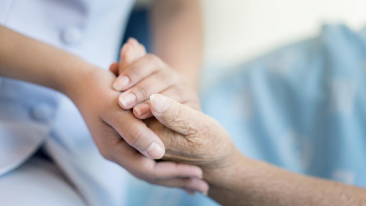 nurse_sitting_hospital_bed_older_woman_helping_hands_73503_1315_78761300