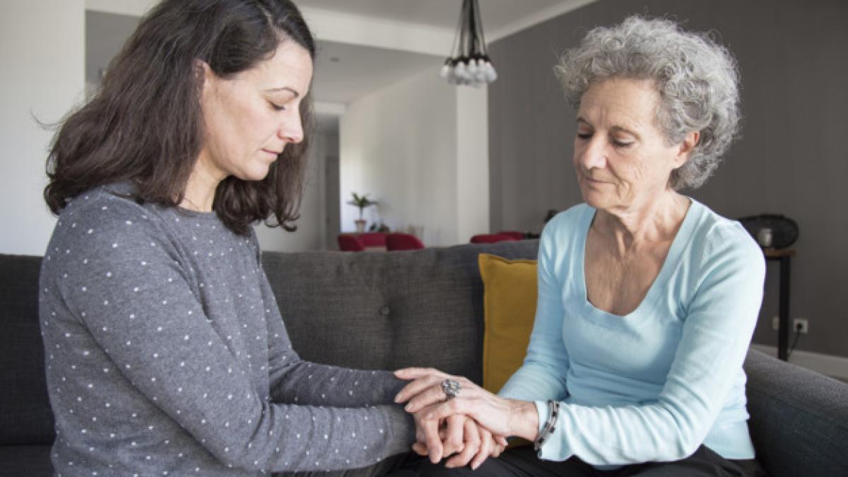serious_senior_woman_her_daughter_holding_hands_1262_18623_28354200