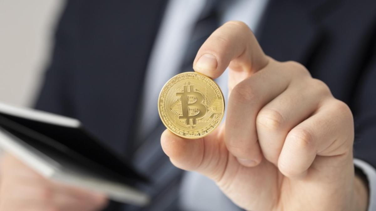 businessman-holding-bitcoin-close-up_23-2148793761_32969300