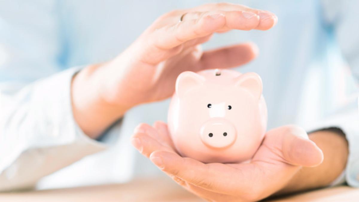 male-hands-holding-taking-care-piggy-bank_136401-28_81997100