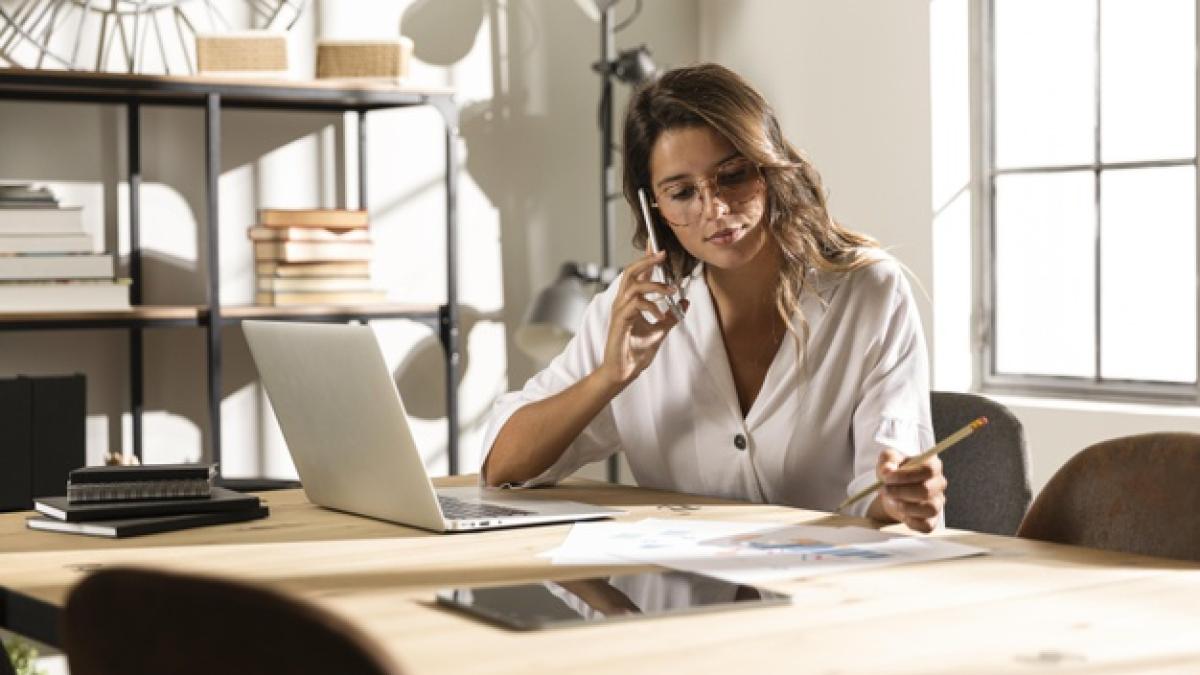 mid-shot-woman-talking-phone-table_23-2148751522_45076000