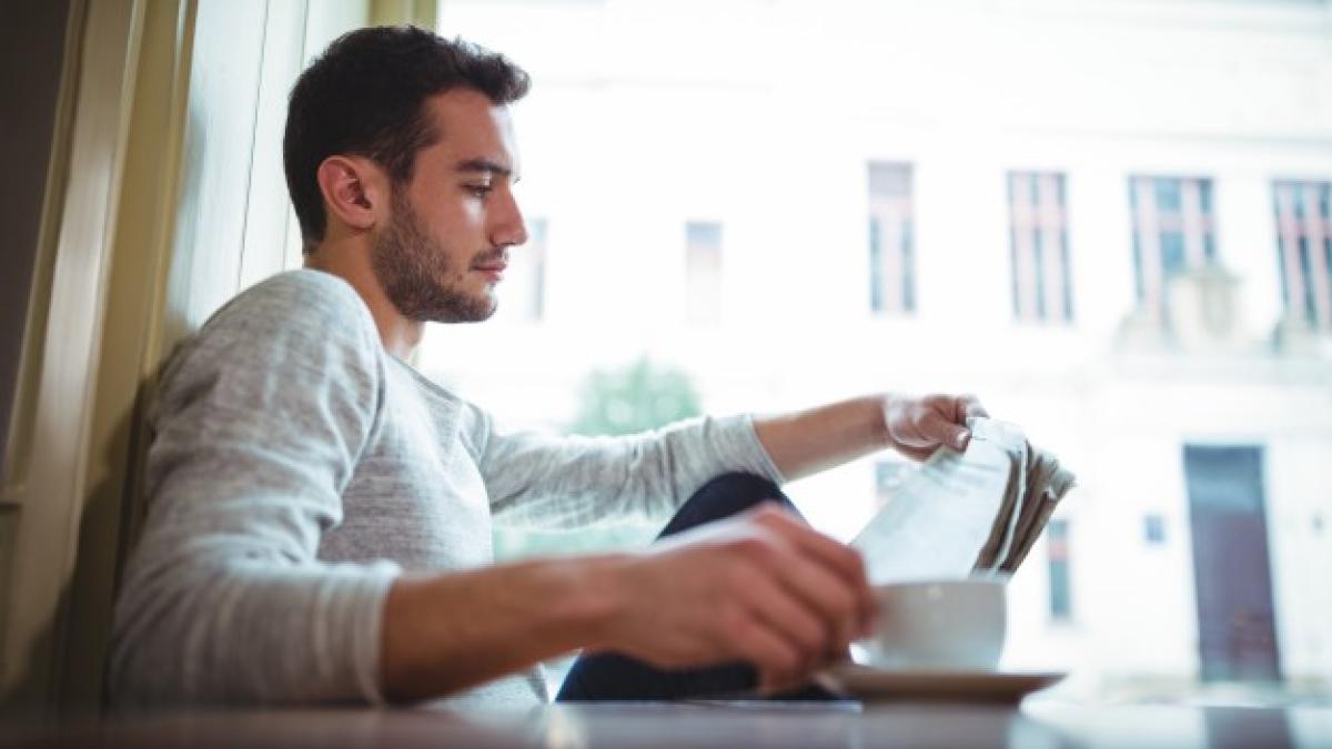 man-having-cup-coffee-while-reading-newspaper_1170-543_13676500
