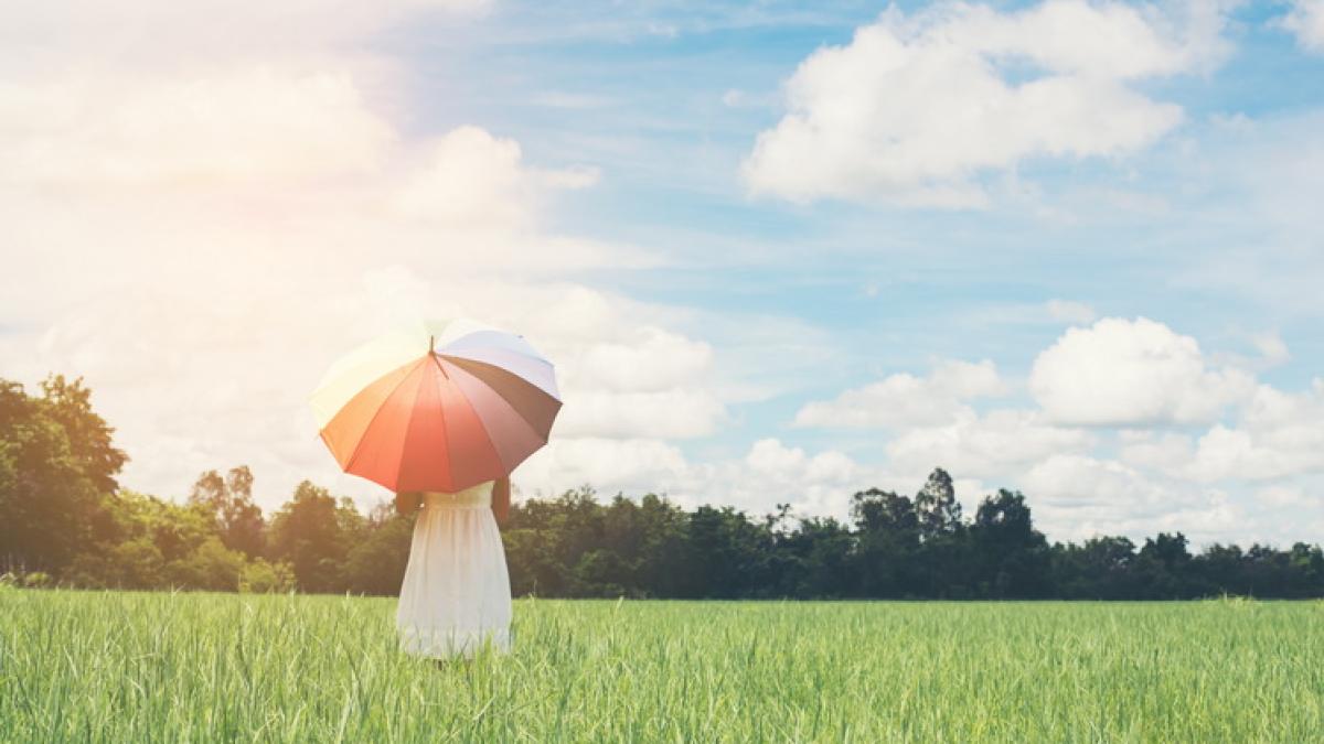 young-woman-with-umbrella-meadow_resize_64224700