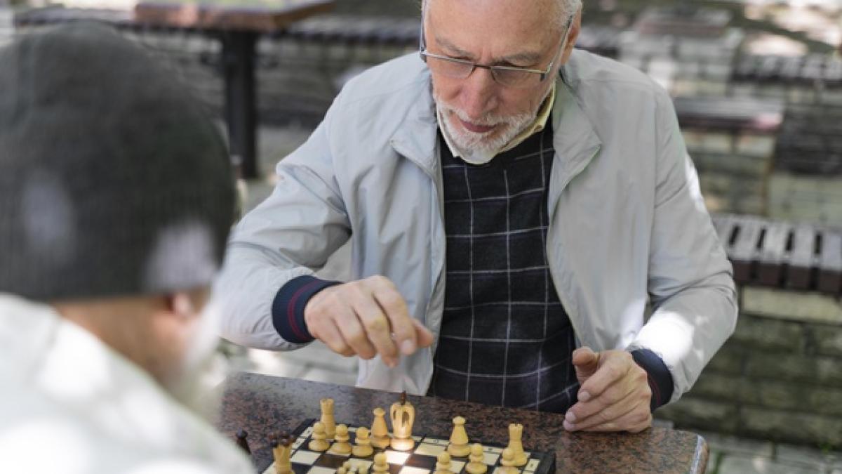 close-up-friends-playing-chess-outdoors_23-2148997199_43781600