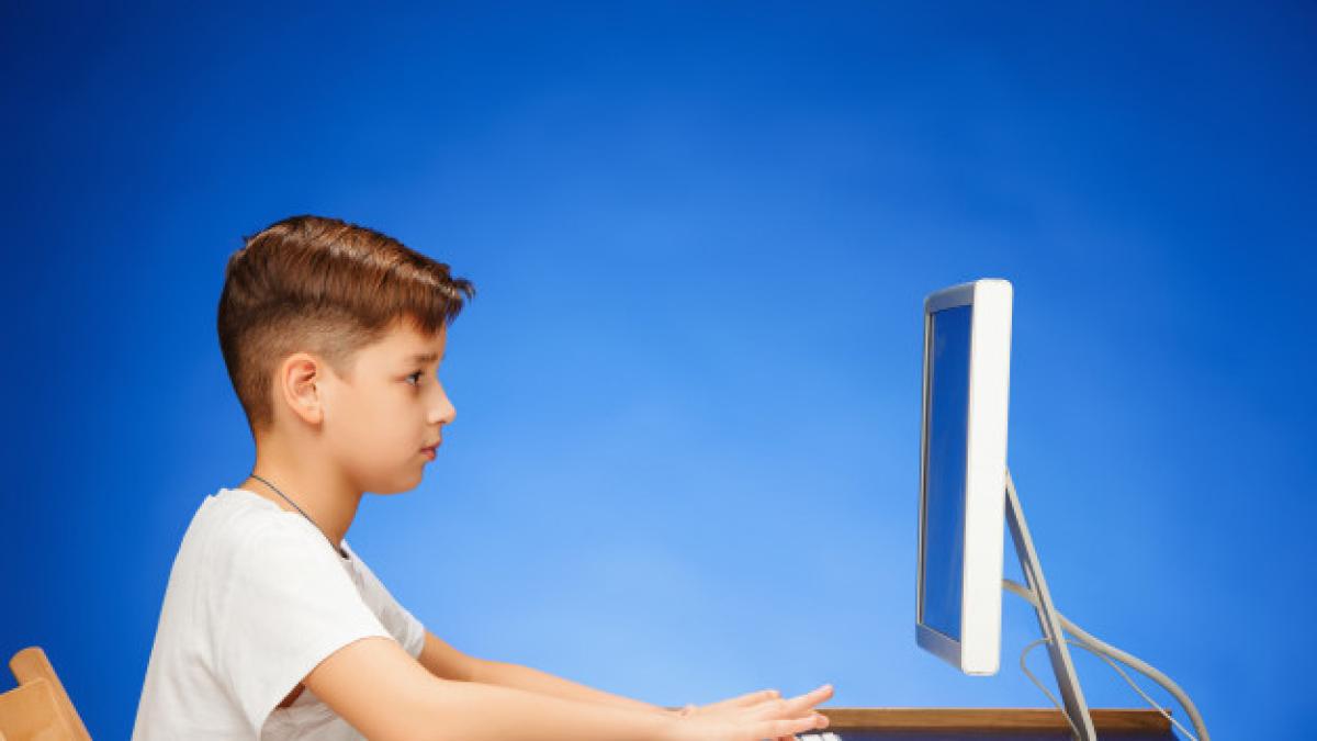 school_age_boy_sitting_front_monitor_laptop_155003_13706_14374900