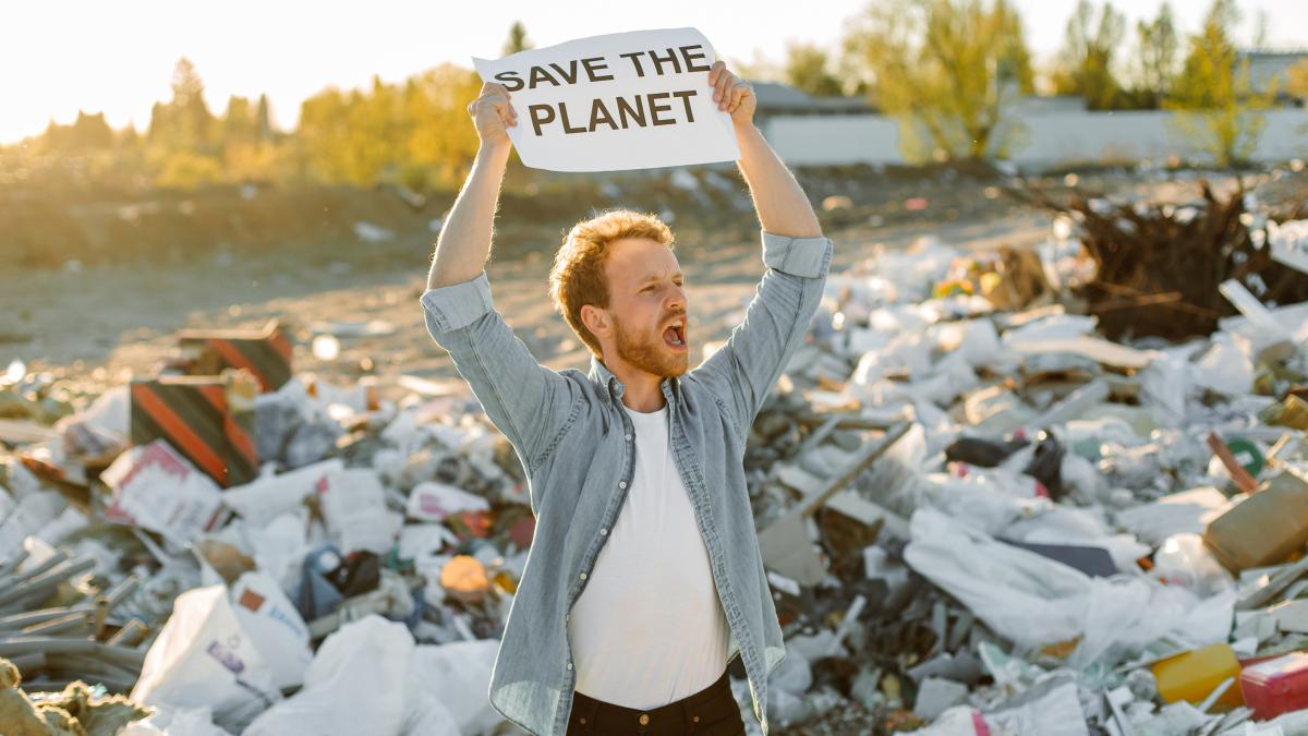 portrait-young-man-fighting-nature-holding-save-mother-earth-sign-dump-protesting-against-nature-pollution-waving-hands-calling-save-planet_60219500