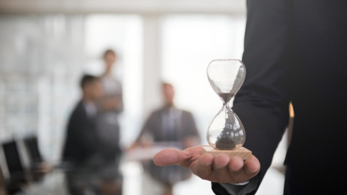 businessman_holding_hour_glass_signifies_importance_being_time_53876_13940_03332700