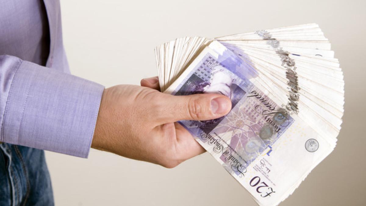 businessman-is-holding-pound-his-hand_11055-2336_53702900