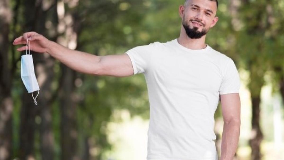 man-holding-his-medical-mask-him_23-2148687249_93151400