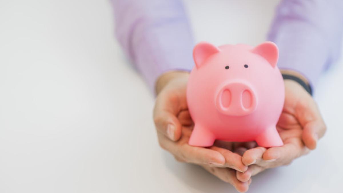 businessman-suit-holding-pink-piggy-bank-with-both-hands-isolated-white-background_1391-162_04723400