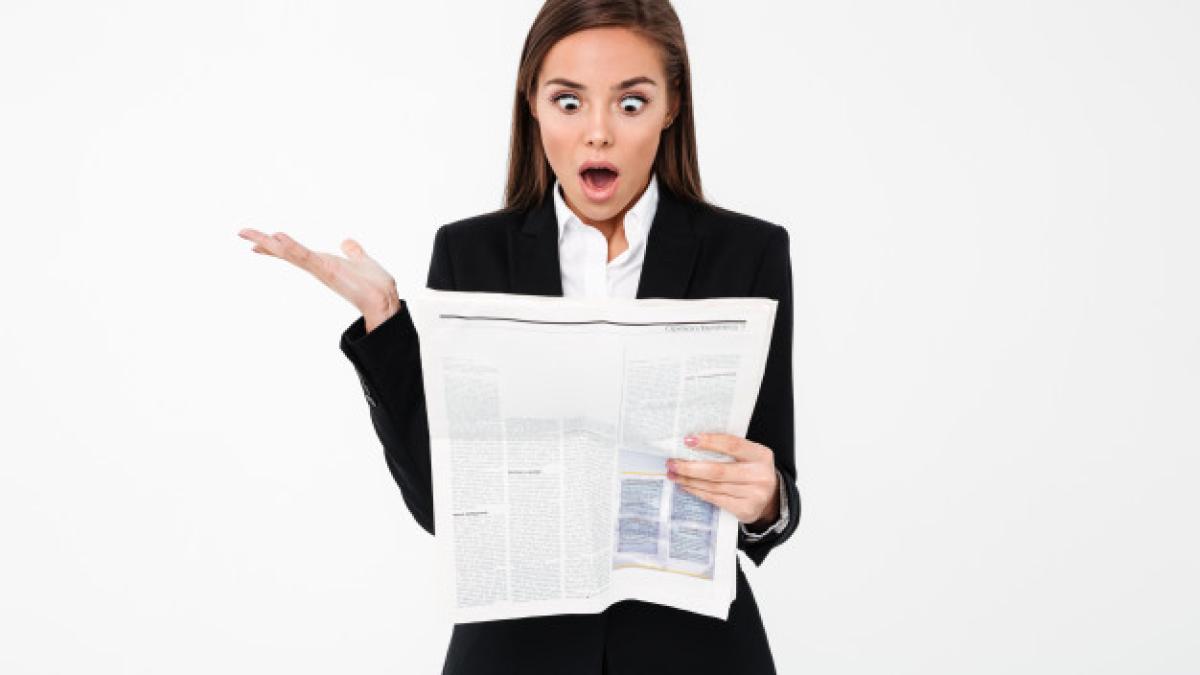 shocked-business-woman-holding-newspaper_171337-8510_59331900