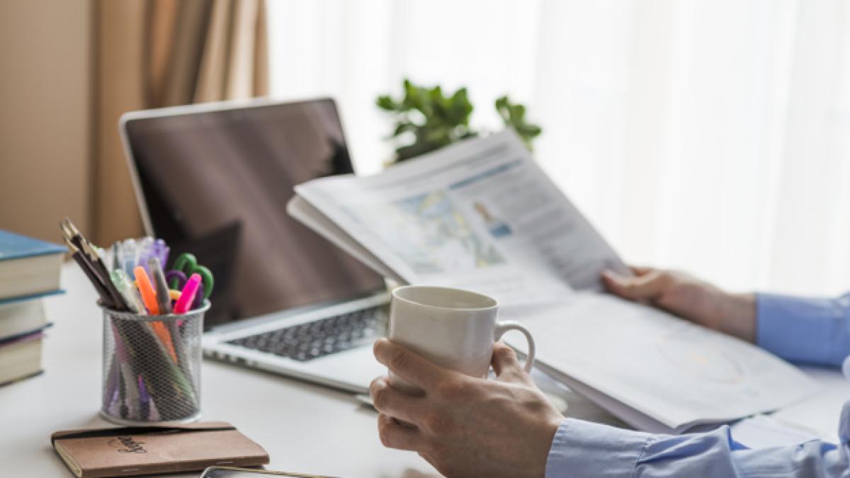 man_reading_newspaper_office_23_2147772286_50363700