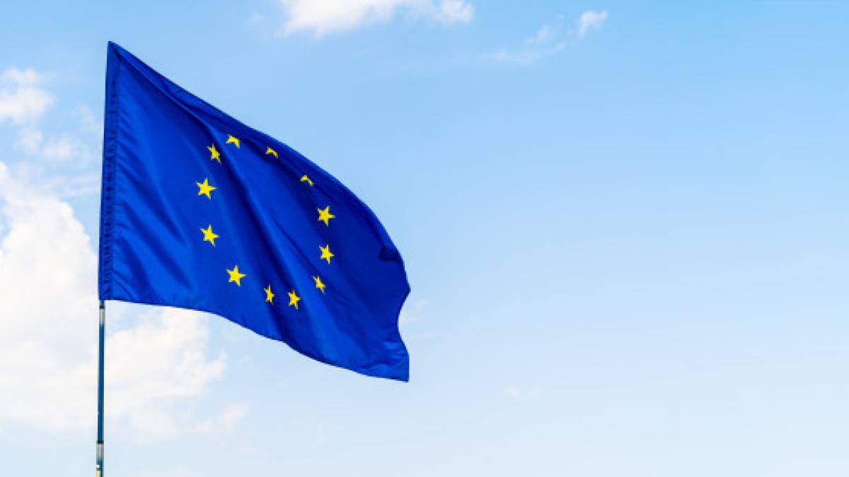 european_union_flag_against_blue_sky_waving_93675_40044_15518000