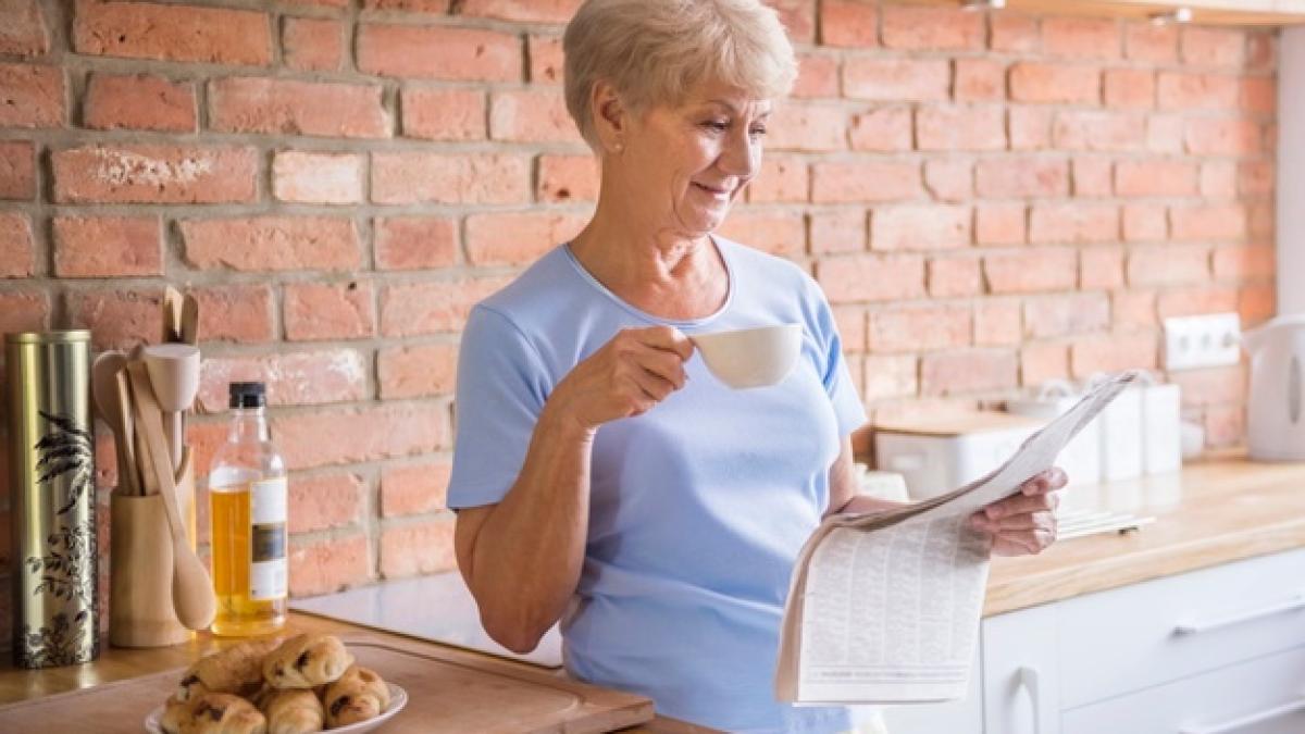 senior-woman-reading-newspaper-kitchen_329181-7821_96621700