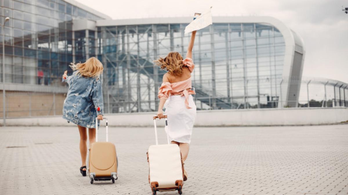 two-beautiful-girls-standing-by-airport_1157-25506_59870100