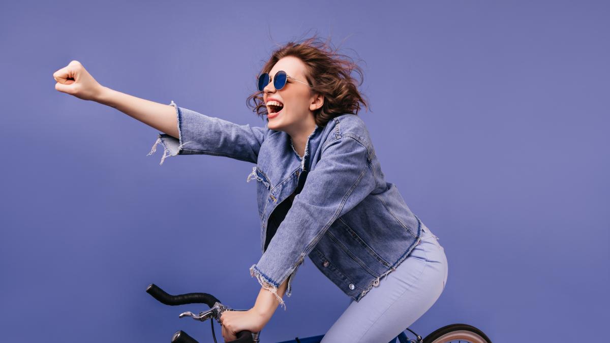 laughing-trendy-lady-sitting-bicycle-waving-hand-portrait-adorable-caucasian-female-bicyclist_25213300