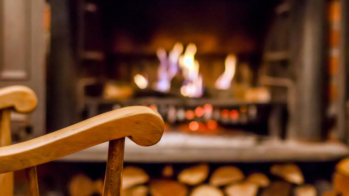 home-comfort-rocking-chair-near-fireplace-photo-interior-room-rocking-chair-living-room-with-decorated-modern-fireplace_22028400