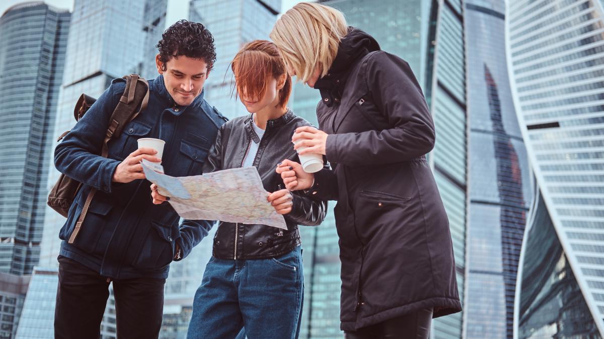 group-tourists-searching-place-map-front-skyscrapers-moscow-city_60742200