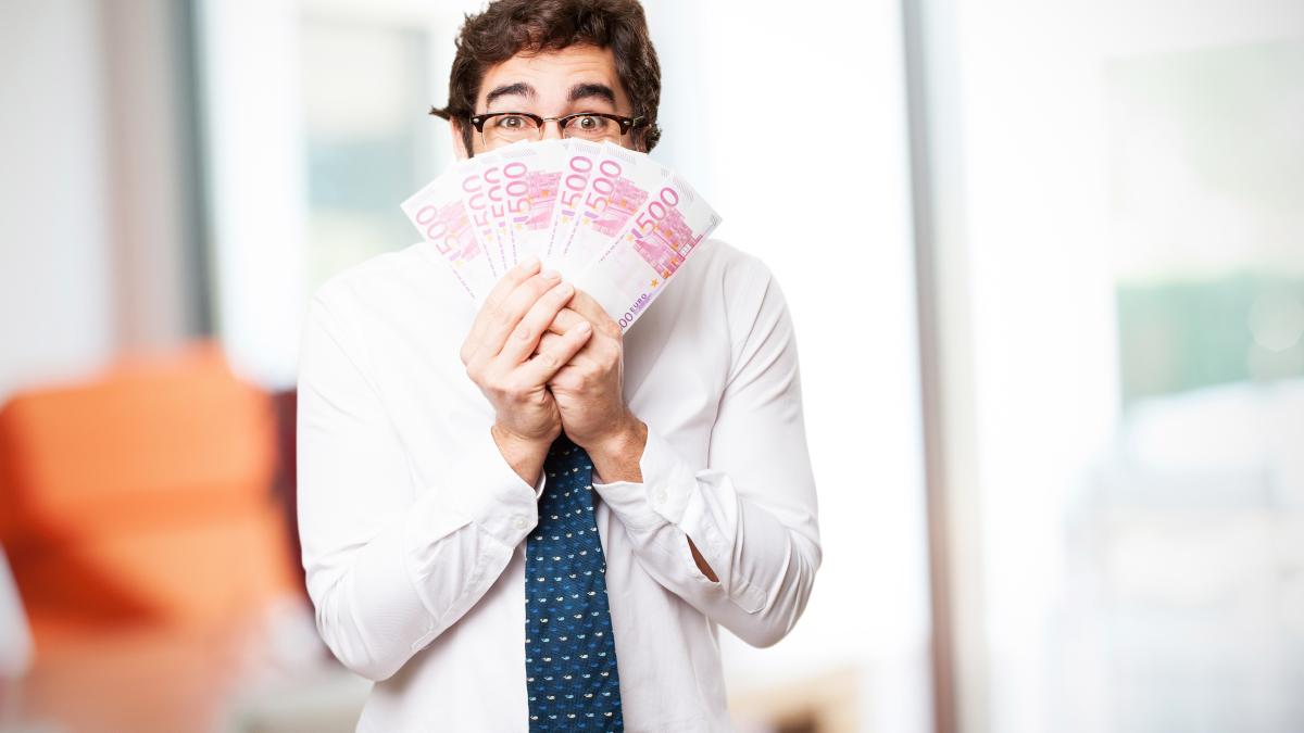 man-covering-his-face-with-bills_95004400