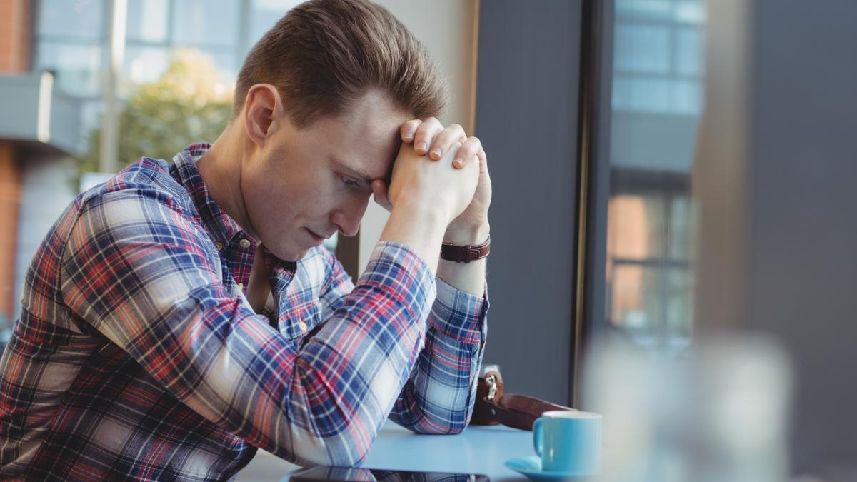 upset-man-standing-with-hand-forehead_40757600